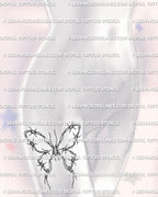Barbed wire butterfly tattoo shown on women’s thigh placement with shaded wire loops and sharp curved barbs