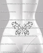 Baroque butterfly tattoo shown across a woman’s lower back with broad filigree wings, mirrored botanical ornament, and a centered jewel drop