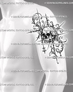 Baroque skull tattoo shown on a man’s upper arm with dark eye sockets, cracked bone shading, layered acanthus curls, and gothic pointed ornament