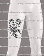 Blackwork rose scorpion tattoo displayed on men's front thigh, with shaded petals, raised tail, claws, and strong stencil contrast
