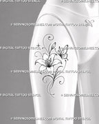 Butterfly and lily tattoo shown on women’s thigh with a detailed flower, fine wing lines, long leaves, ornamental curls, and small celestial accents