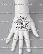 Celestial winged eye tattoo shown on the back of the hand with stylized seraphim wings, ornamental curls, stars, and open illustrative linework
