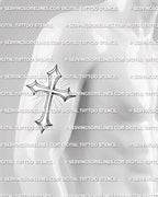 Cross with rays tattoo stencil shown on mens arm placement, with clean vertical shape and shaded cross design.