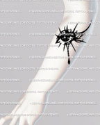 Forearm tattoo display of crying eye with gothic third eye symbolism and neotribal black linework.