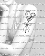Cute creepy candy tattoo shown on womens arm with heart lollipop design, bow handle, and black and white stencil style.