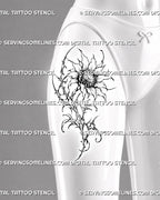 Dark cyber floral sunflower tattoo shown on a woman’s thigh with pointed petals, a thorned stem, abstract leaves, stippling, and gothic botanical details