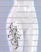 Feminine floral tattoo shown at a more compact scale on a woman’s upper thigh with an ornamental lily, flowing scrollwork, stars, and jewelry-like details