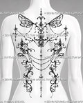 Feminine ornamental back tattoo shown as a women’s backpiece with gothic fairy wings, symmetrical filigree, draped chains, jewel details, and pendant accents