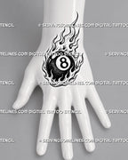 Fire 8 ball tattoo shown on the hand with a compact billiard ball, clear number panel, curved flames, and strong black-and-white contrast