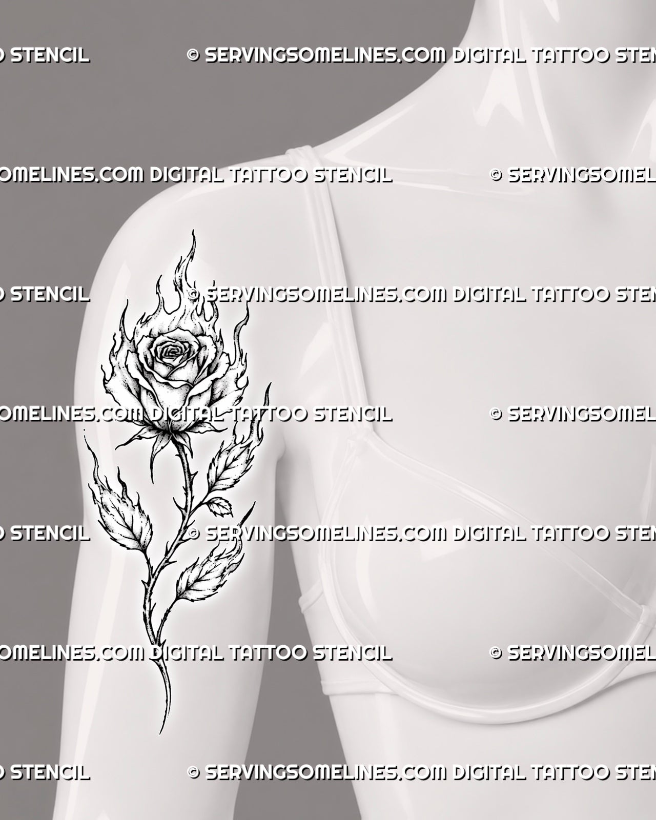 Fire rose tattoo shown on the front of a woman’s upper arm with flaming petals, a long thorned stem, branching leaves, and black-and-grey detail