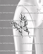 Flaming butterfly tattoo shown on a woman’s front thigh with four spread wings, long fire extensions, layered sections, and bold illustrative linework
