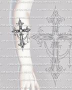 Gothic cross tattoo stencil shown on forearm with ornate blackwork detail, pointed shape, and decorative chain accents