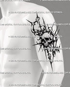 Gothic neotribal skull tattoo shown on a man’s outer upper arm with spiky blackwork extensions, stippled texture, rings, and dark sigilism details