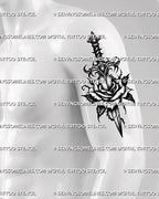 Gothic rose dagger tattoo stencil displayed on men’s biceps placement, with dark floral center and vertical dagger shape 