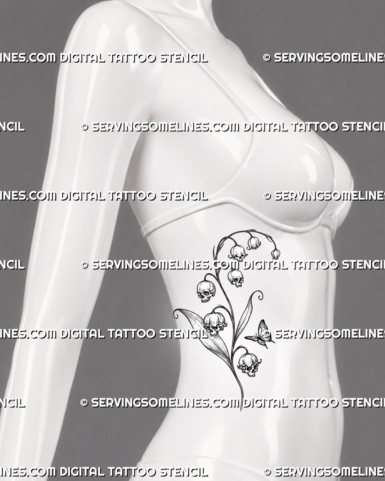 Lily of the valley with skulls tattoo shown on women’s side body with a curved botanical stem, hanging skull flowers, long leaves, and butterfly detail