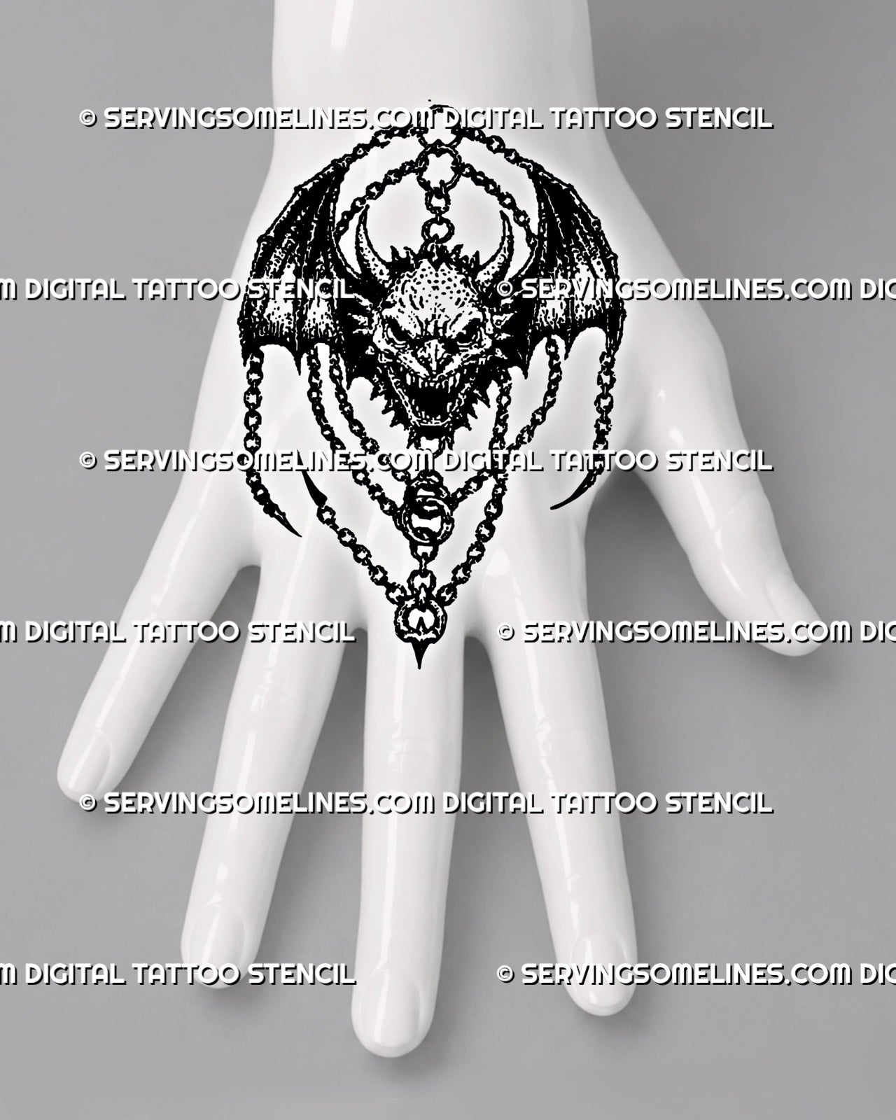 Medieval demon tattoo stencil shown on top of hand with horned face, bat wings, chain detail, and compact dark fantasy shape