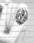 Mythic unicorn tattoo stencil shown on women’s arm with full-body rearing unicorn, old-world vines, sword, chain detail, and fantasy tattoo shape
