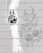 Neotribal cherry tattoo stencil shown on forearm with elongated tribal framing, paired fruit, heart-shaped negative space, hooked curves, and star details
