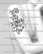 Ornamental rose tattoo shown on women’s upper arm with a large central flower, sweeping filigree curls, botanical leaves, and baroque-inspired details