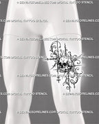 Ornate skull tattoo shown on a man’s front thigh with a weathered skull, structural filigree curls, hanging diamond ornaments, and a tall asymmetric silhouette