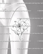 Outline lily flower tattoo shown on the front of a female thigh with a large open bloom, flowing stem, leaves, and decorative floral curls