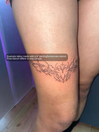 real tattoo example of a small cybersigil heart placed above the knee, healed ornamental linework showing how the stencil looks on skin
