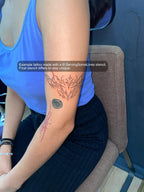 real tattoo on womens arm showing small cybersigil heart design with light ornamental curves, example result made from ServingSomeLines stencil