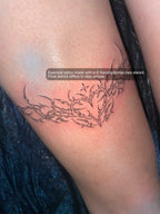 real tattoo example of ornamental heart design on a womans thigh showing fine line details and clean healed feminine linework
