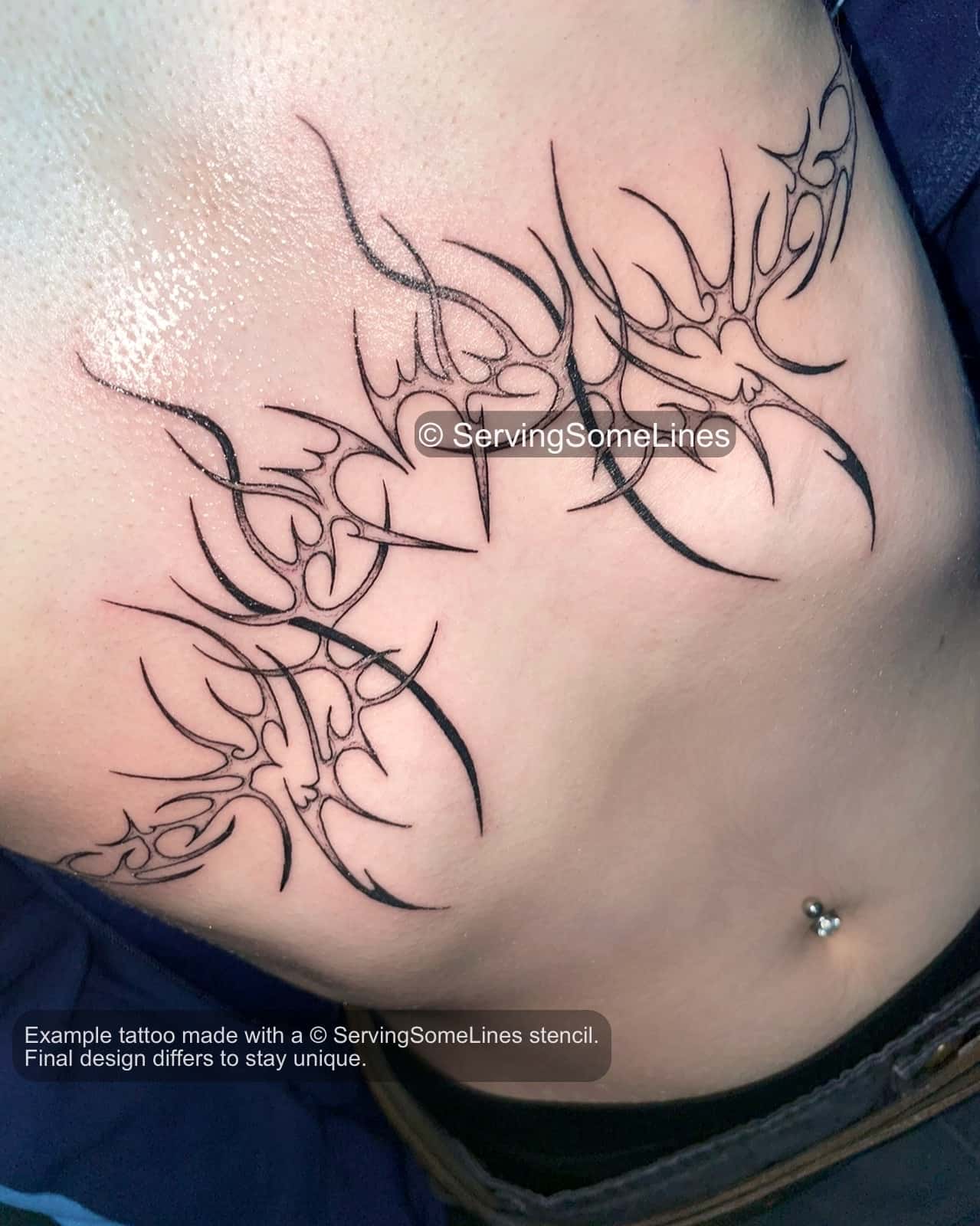 real tattoo example on womens skin showing heart underbust tattoo with ornamental lines shaped to fit natural chest and rib curves