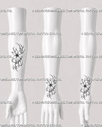 Small flower tattoo stencil shown on forearm and wrist with compact cybersigilism floral design, open petals, and clean cyber linework