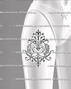 Two swans heart tattoo shown on a woman’s front thigh with broad feathered wings, mirrored filigree, central heart ornaments, and a tall symmetrical composition