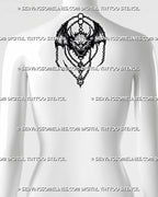 Winged demon tattoo stencil shown on upper back with wide bat wings, horned face, chain details, and medieval fantasy styling