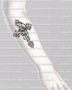 Baroque cross tattoo design shown on forearm placement, decorative filigree outline with gothic scrollwork and clean line detail