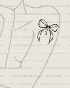 woman wearing a small gothic bow tattoo stencil with devil heart detailing displayed on shoulder placement for feminine coquette style