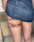 Real cyber sigilism tattoo stencil example tattooed on woman’s back thigh, heart tribal design with ornamental spikes and alt aesthetic. 