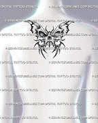 Dark butterfly tattoo design shown on women's upper back, with a skull body, sharp wings, and bold centered placement.