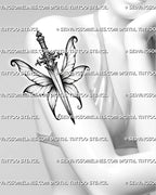Fairy dagger tattoo stencil shown on women's arm, with a slim blade, ornate gem hilt, and fairy wing detail.