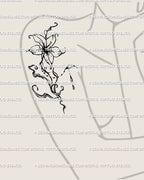 Fluid flower tattoo stencil displayed on woman’s upper arm and shoulder area, showing flowing lily lines in soft liquid blackwork. 
