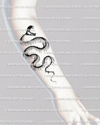 Snake skeleton tattoo displayed on forearm, vertical serpent linework flowing with the wrist and bone form. 