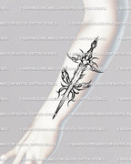 Forearm view of a gothic dagger tattoo with flames—butterfly wings form the guard, slim vertical layout for everyday wear, sharp yet elegant line art.