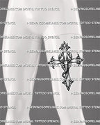 Gothic cross scorpion tattoo displayed on men’s thigh with a long vertical shape, hooked stinger, raised claws, and shaded details.
