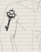 Gothic skull key tattoo stencil shown on mens biceps placement example, skull top with thorn crown, bold blackwork for transfer.