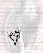 Heart tribal tattoo stencil displayed on womens hip placement, black tribal heart tattoo with bold outline and negative space.