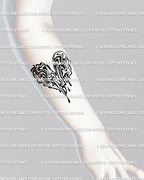 Liquid marble heart tattoo stencil displayed on forearm placement, showing glossy melting effect and smooth abstract drip pattern on skin.