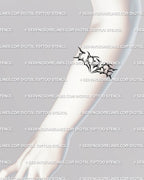 Digital LOVE lettering tattoo stencil shown horizontally across the forearm, blackwork tribal lettering with heart-spiked center for balance.