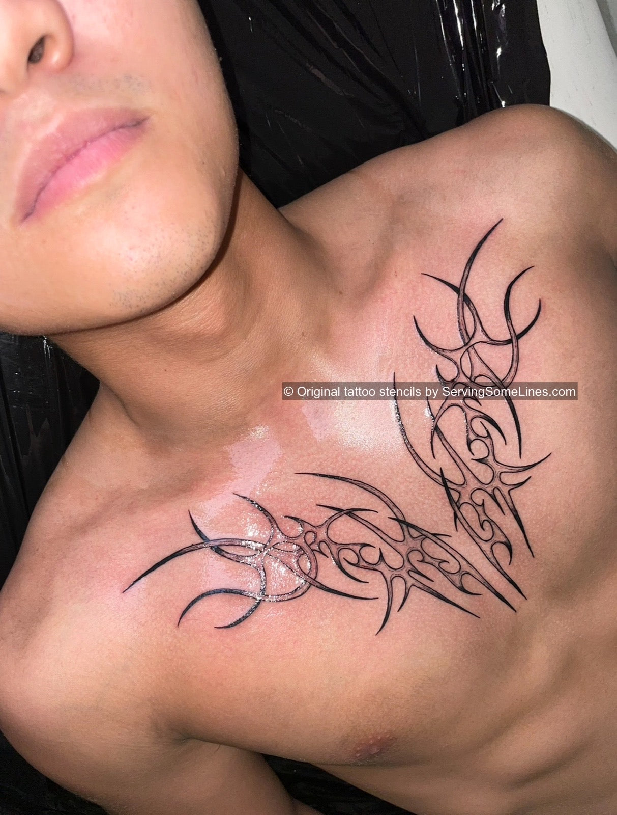 Ornamental neotribal and cyber-edge tattoo on men’s center chest, outline design with ornamental symmetry and sharp line flow
