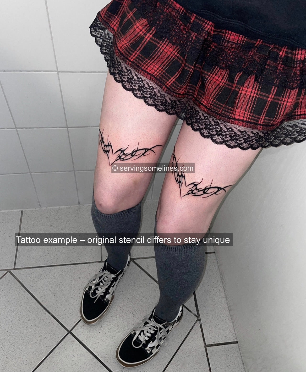 Neotribal heart tattoo shown tattooed on both front thighs with a compact heart shape and sharp tribal framing