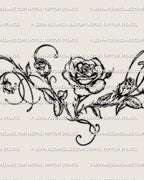 Close detail of the rose vine tattoo, showing the central bloom, buds, leaves, and curved linework.