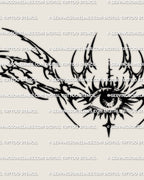 Close detail of the sharp tribal eye lower back tattoo stencil showing the central eye, lashes, and hooked outer points.