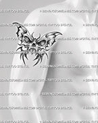 Skull butterfly tattoo stencil shown on men's upper arm, with bold skull body, dark wing panels, and sharp gothic placement.

